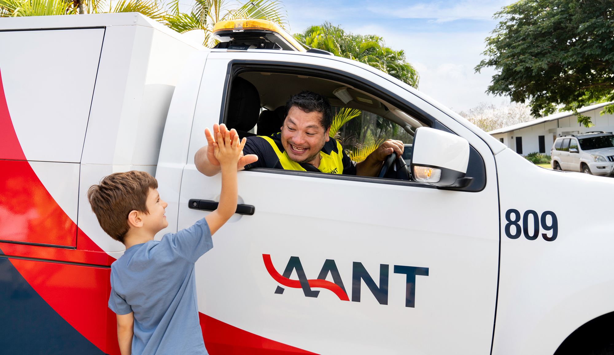 Kids giving a high-five to AANT patrol officer