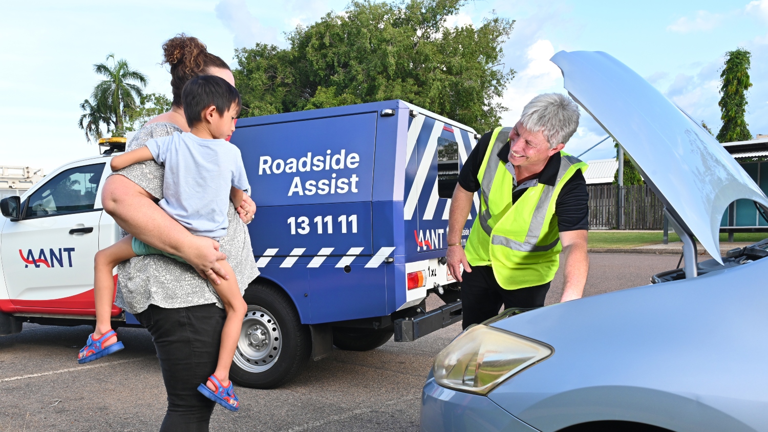  Roadside assistance service person helping a mother and her son.