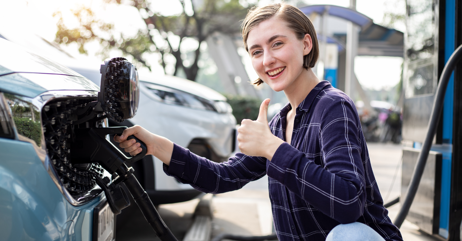 Young woman charging her ev