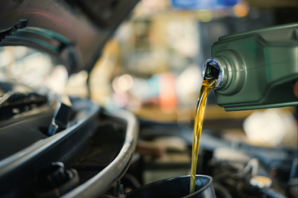 Pouring oil into a car engine 