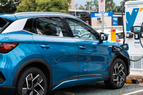 Blue car charging at an EV charging station in Darwin 