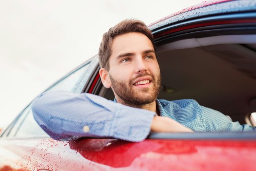 Man leaning out of the window of his car